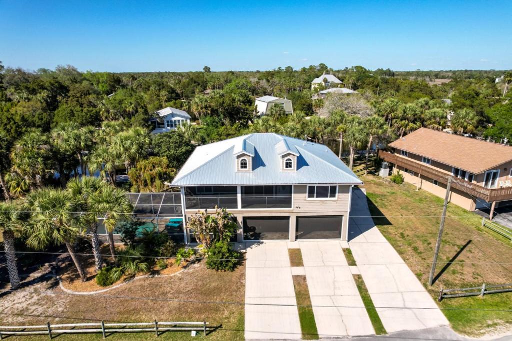 Woods N Waters House | Canal home with pool, kayaks, private dock, firepit sleeps 9