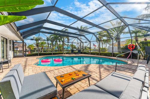 Cocoa Isles Villa | Casa De Olas - Waterfront Luxe Home - Heated Pool - Game Room - Boat Lift - Minutes to Beach