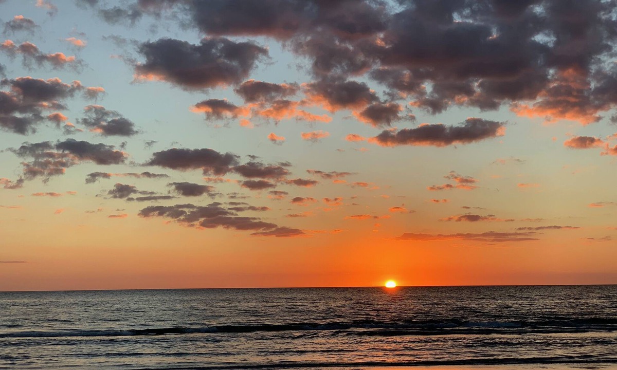 Indian Shores Condo | Enjoy beautiful sunsets from the balcony or wade into the waves just steps away!