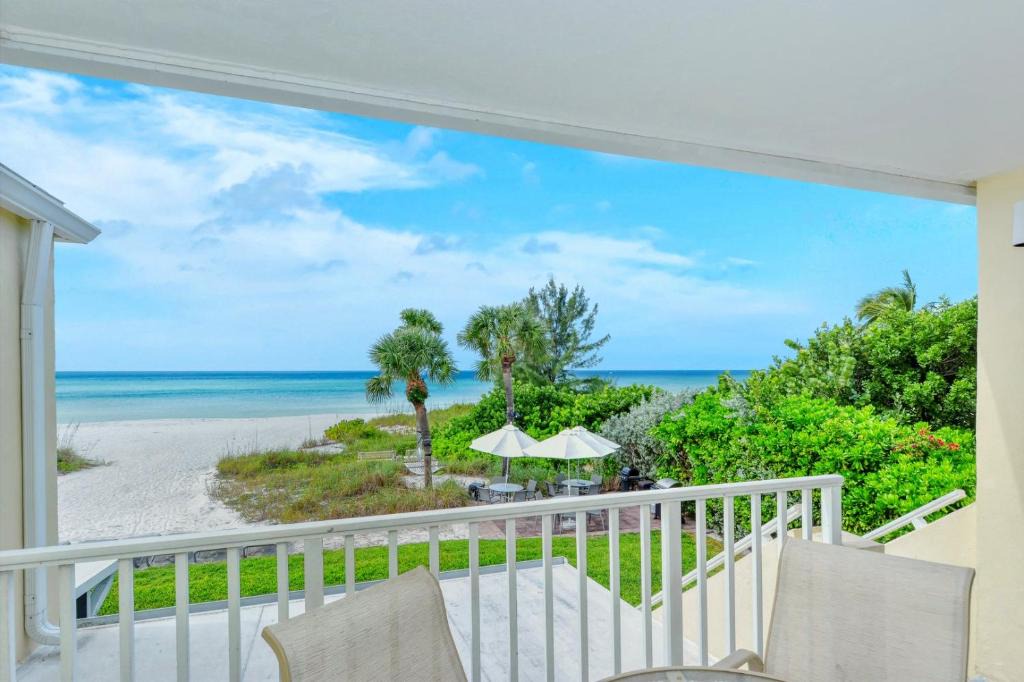 Longboat Key Apartment | LaPlaya 201C Breathtaking Gulf panorama from this corner end unit with a private stairway to the beach