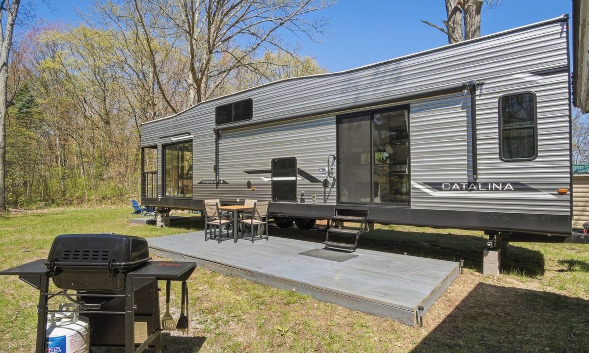 Fountain House | Round Lake Getaway Camper: Full Kitchen, 2 BR's, Dock, Pedal Boat Near Ludington
