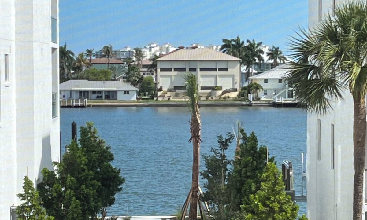 Vanderbilt Beach Condo | TOP FLOOR BAY VIEW, ROOFTOP POOL, STEPS TO VANDERBILT BEACH!