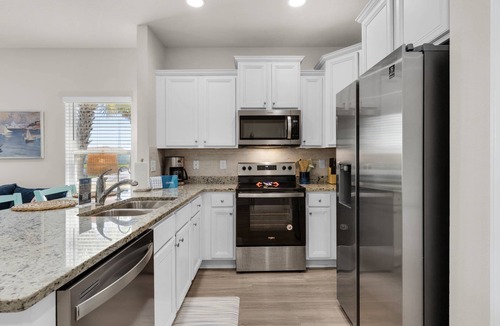 Thomas Drive House | Coastal Panama City Beach Retreat | Pet-Friendly, Private Deck, Pool, Garage, & $300 Fee Fun!