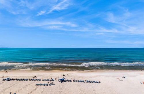 Miramar Beach House | Colorful oceanfront condo with Gulf views on-site pools & hot tub