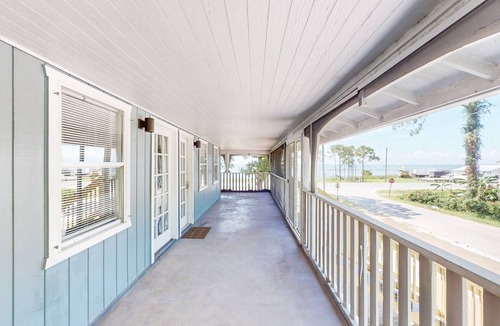 Eastpoint House | Dog friendly home overlooking the Gulf with classic veranda, yard & sunrise view