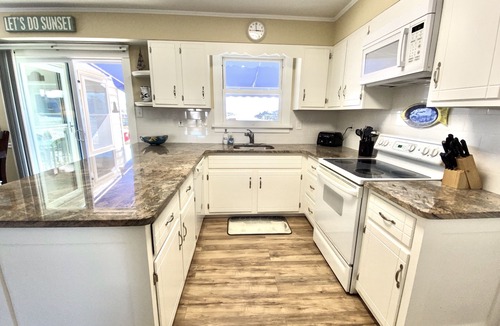 Avalon House | ENJOY BAY VIEWS! Bayfront home, shady front porch 2 boat docking areas, gameroom to watch TV, A short bike ride or walk to Avalon's fine business district for ice cream, dining, mini golf, shopping and more.