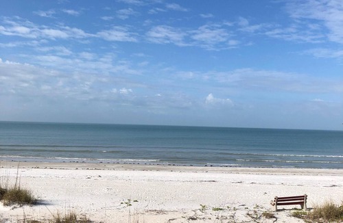 Indian Shores Condo | Enjoy beautiful sunsets from the balcony or wade into the waves just steps away!