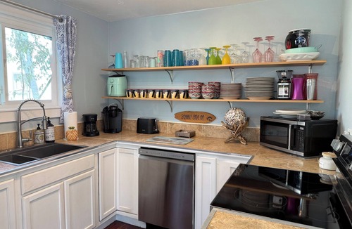 New Smyrna Beach House | Historic Courtyard Cottage with Pool, 1 block to Flagler Ave! Sleeps up to 10