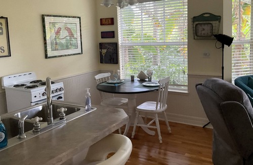 New Smyrna Beach Cottage | Kingfisher Cottage on Canal and two blocks to Ocean, amidst a tropical landscape