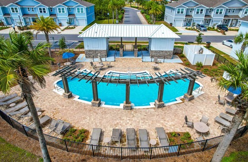 Thomas Drive House | Modern 3BR Townhome | Pool Access | Near Publix Sports Park & Beaches | Sleeps 9