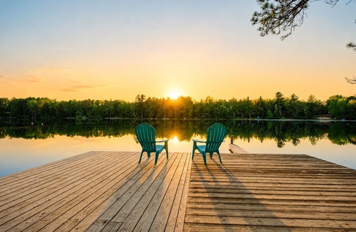 South Boardman House | Peaceful Lakefront Retreat w/Hot Tub, Fire Pit, Game Room, Screened Deck