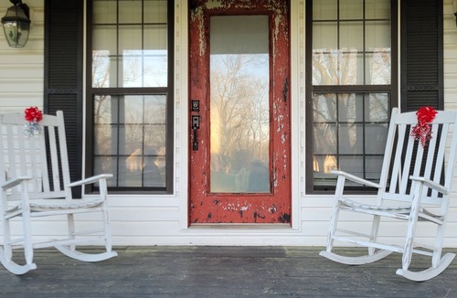 Peach County House | Rocking Chair front porch looking out on sprawling pecan trees filled w/nature.