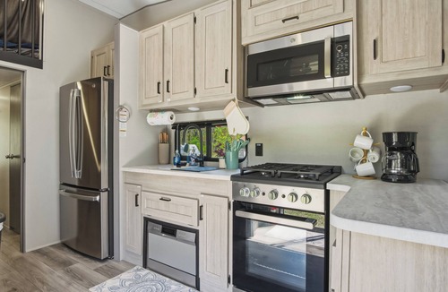 Fountain House | Round Lake Getaway Camper: Full Kitchen, 2 BR's, Dock, Pedal Boat Near Ludington