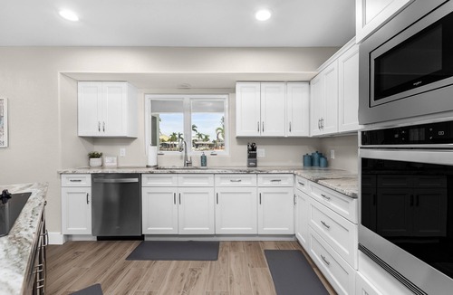 Saint James City House | TWO MASTER SUITES-POOL -WATERFRONT ON CORNER LOT - BOAT LIFT -OUTDOOR KITCHEN