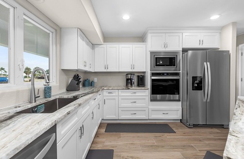 Saint James City House | TWO MASTER SUITES-POOL -WATERFRONT ON CORNER LOT - BOAT LIFT -OUTDOOR KITCHEN