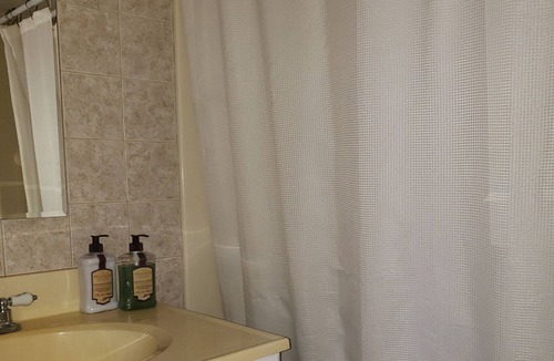 Whitney Beach House | Waterview bedroom, great location steps from Bridge Street