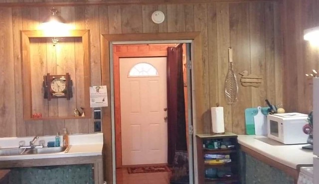 2 BR 2 Bath Cabin on private 1 acre. Huge cement pad for parking. No clay roads.