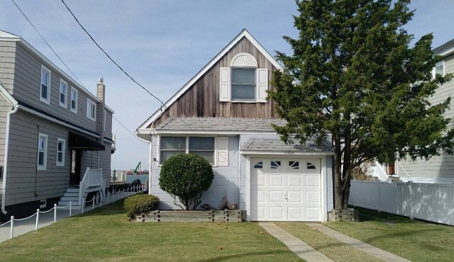 ADORABLE bay front cottage is tucked away on a quiet street with amazing SUNSET VIEWS