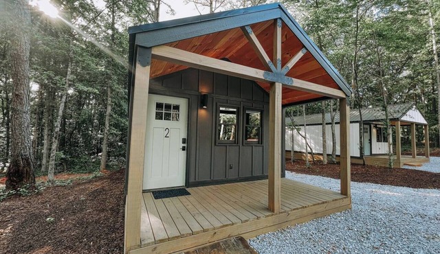 Cabin #2: One king-size bed with a full kitchen for cooking and a large gravel parking pad beside the cabin for easy boat trailer storage.