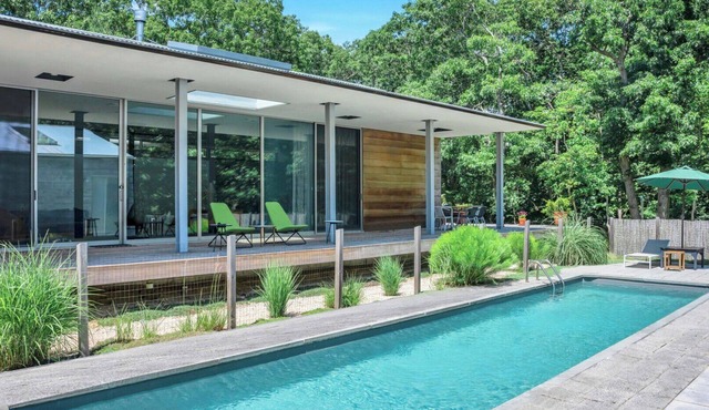 Modern home sited on a lush wood acre, stunning pool, covered deck, outdoor.