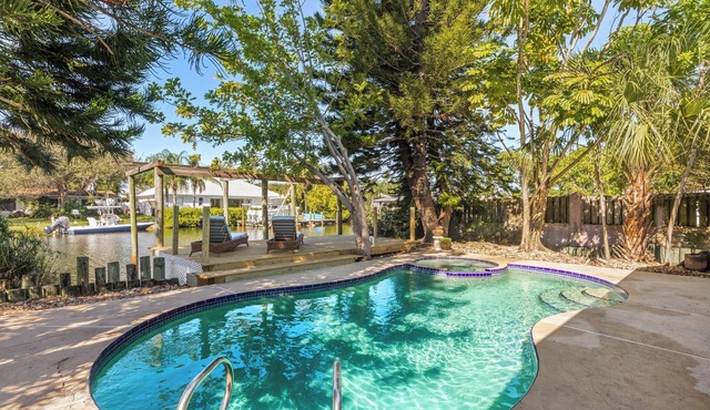 Private wooded 3BR/3BA house w/heated pool on canal just steps from beach