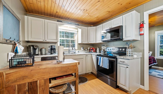 Riverfront oasis with hot tub, firepit, game room, & trail access - dog-friendly